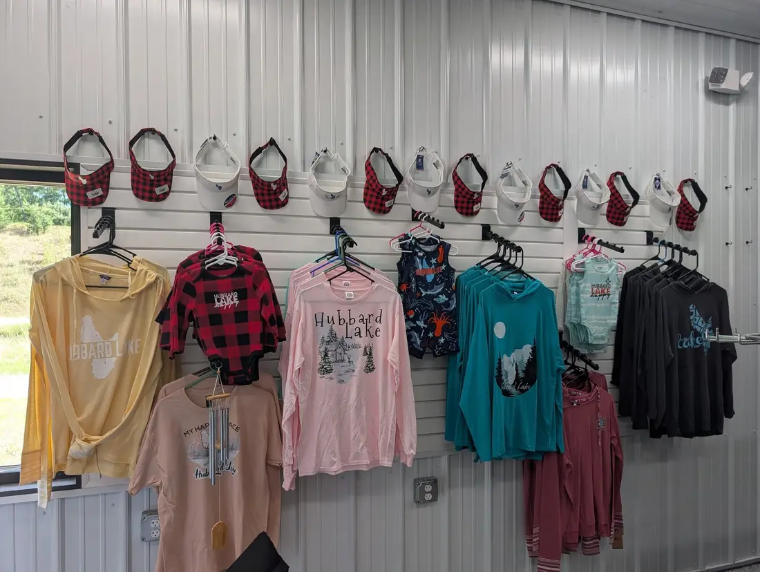 Wall of Hubbard Lake tees, onesies, and flannels